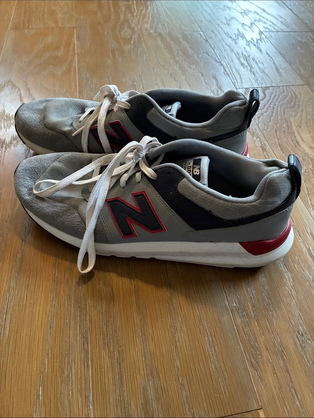 New Balance Gray Sneakers with Red Logo Accent